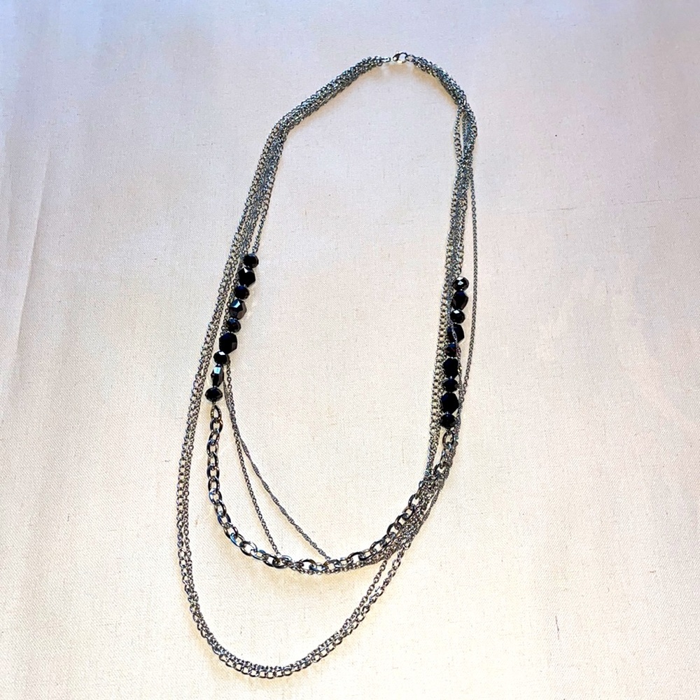Silver layered necklace with black accent beads.